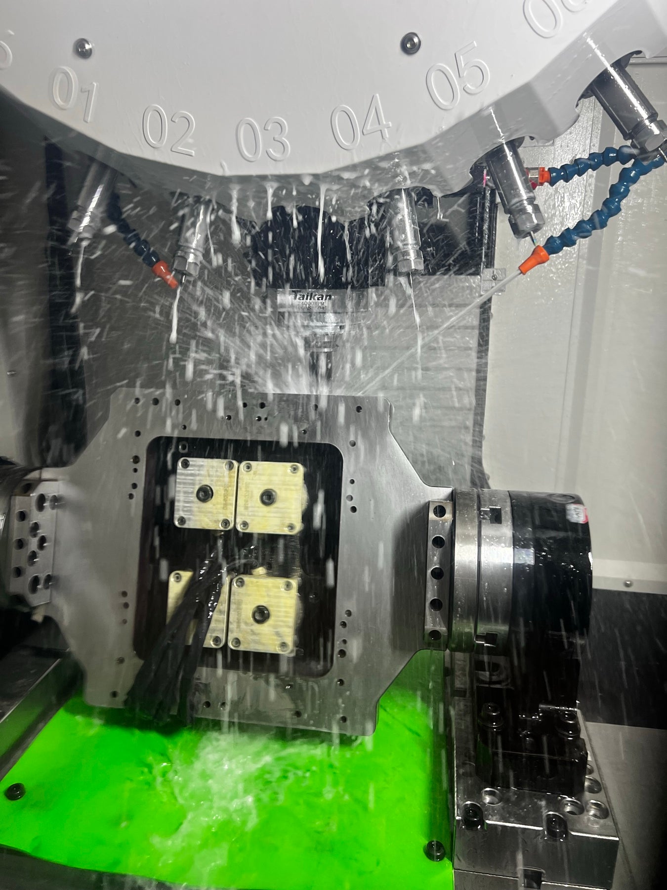 Real CNC rotary-axis retrofit machining under coolant